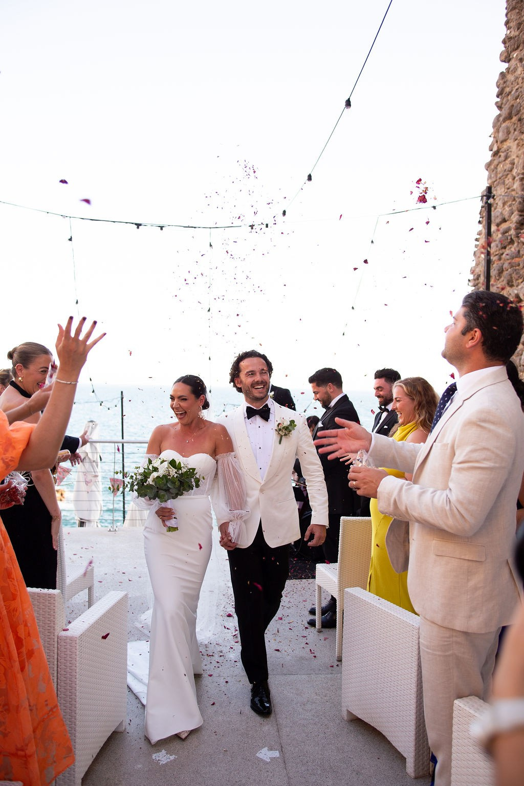 Bride celebrating with guests during a joyful wedding reception in Italy