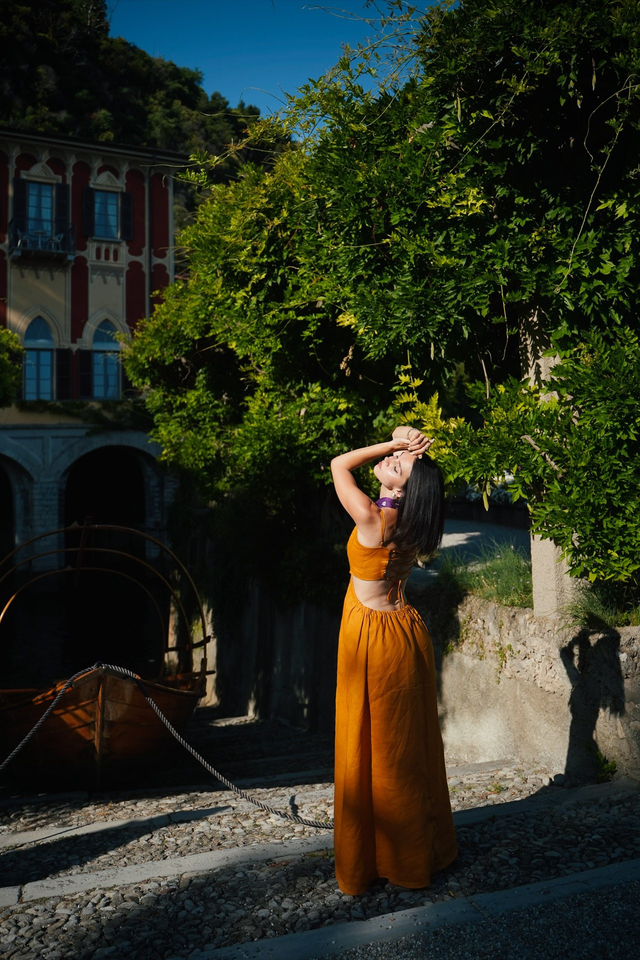 Woman in an orange dress overlooking Lake Como