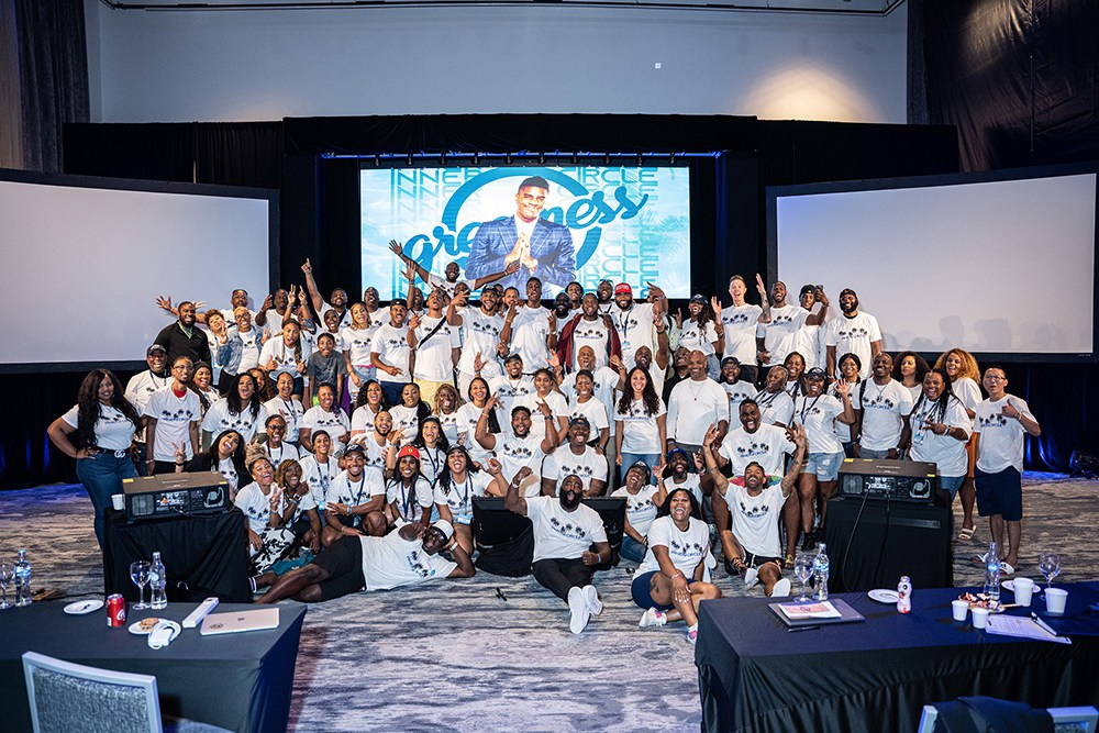 Group photo of all event participants standing together at corporate gathering.