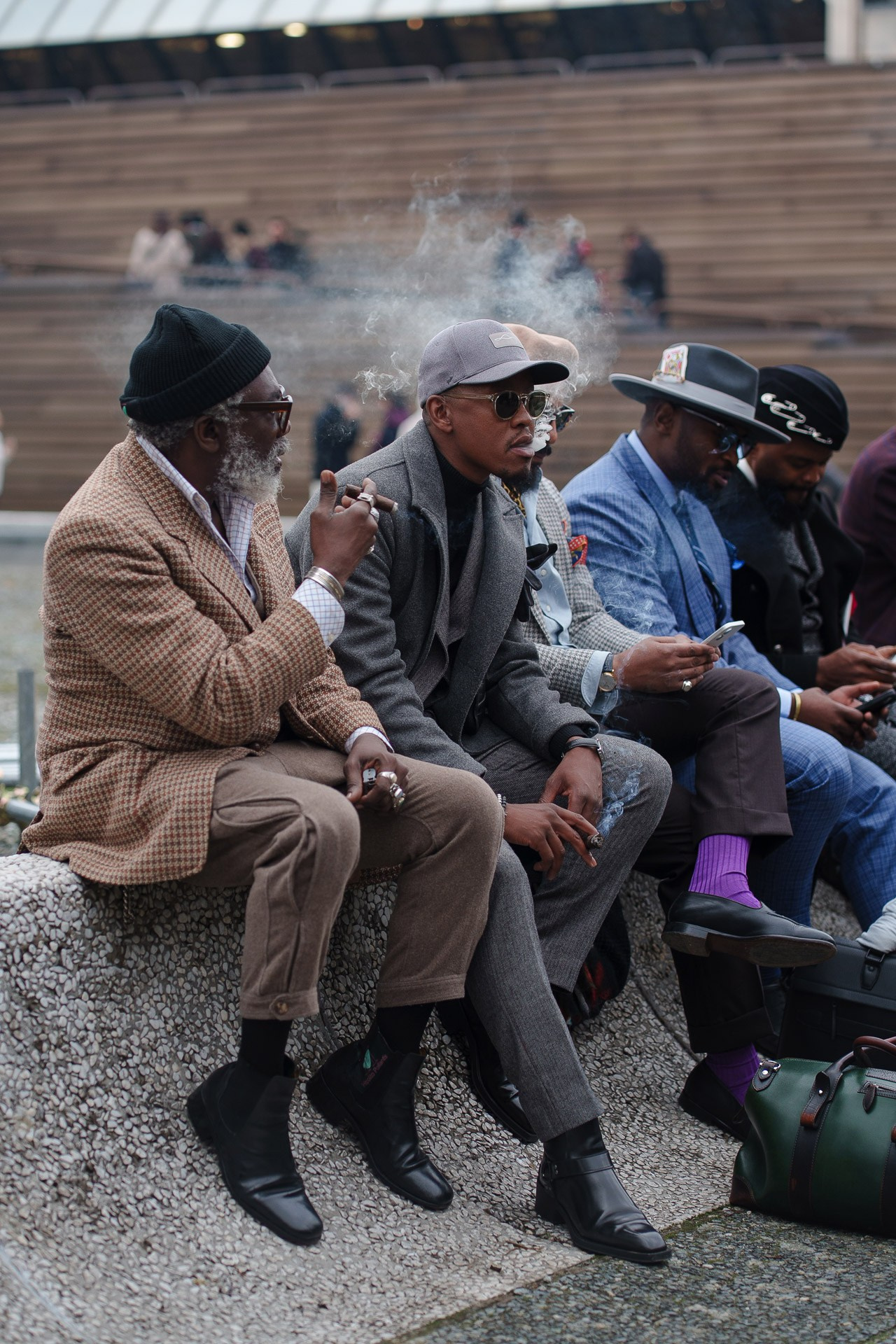 Group of men sitting and smoking cigars at Pitti Uomo 109 Florence