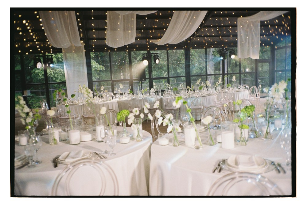 Reception tables under draped ceiling during luxury wedding dinner