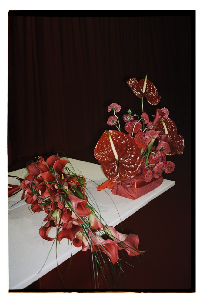 Red bridal bouquet displayed during editorial wedding reception