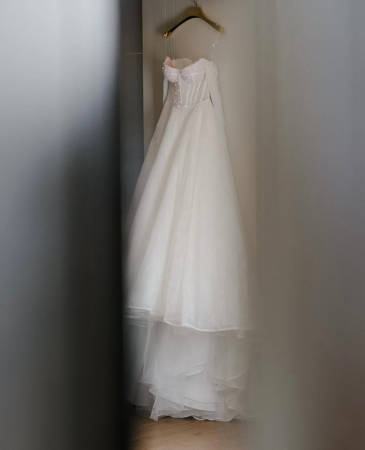 Wedding dress hanging in hotel room