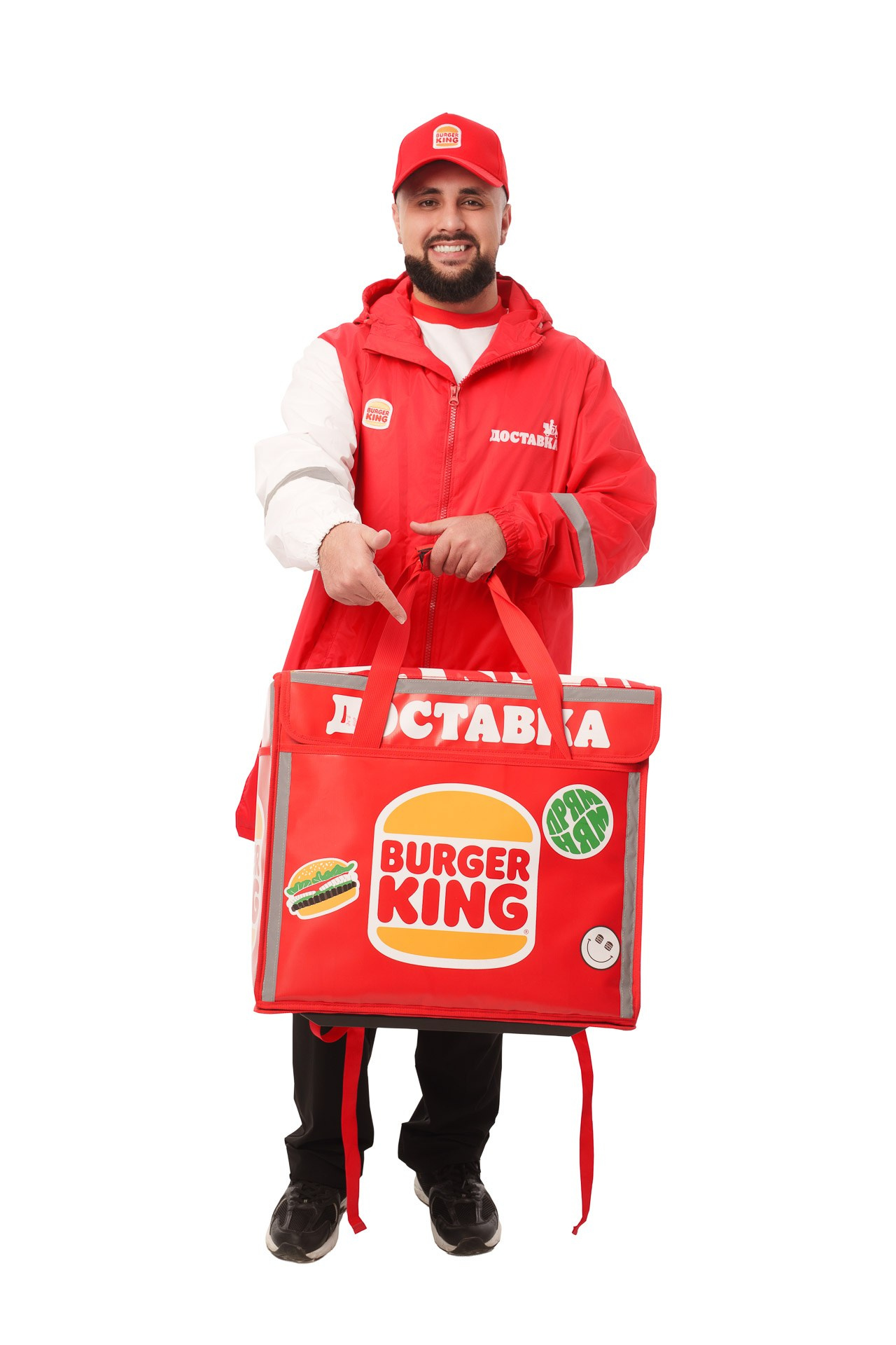 Burger King delivery courier holding insulated delivery bag, studio portrait