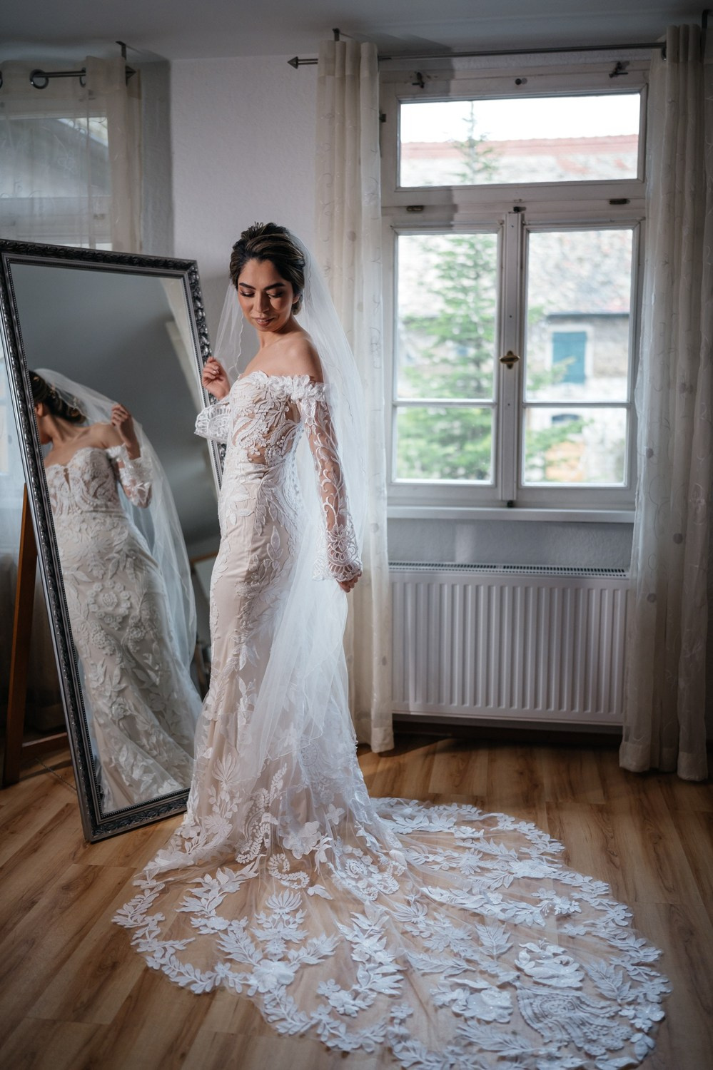 bride gets ready and posing in front of window