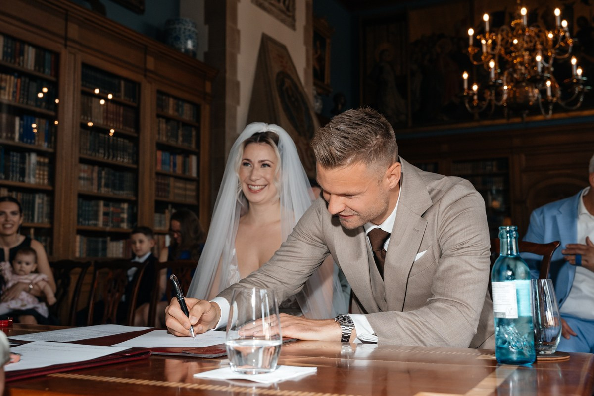 groom signs the wedding contract