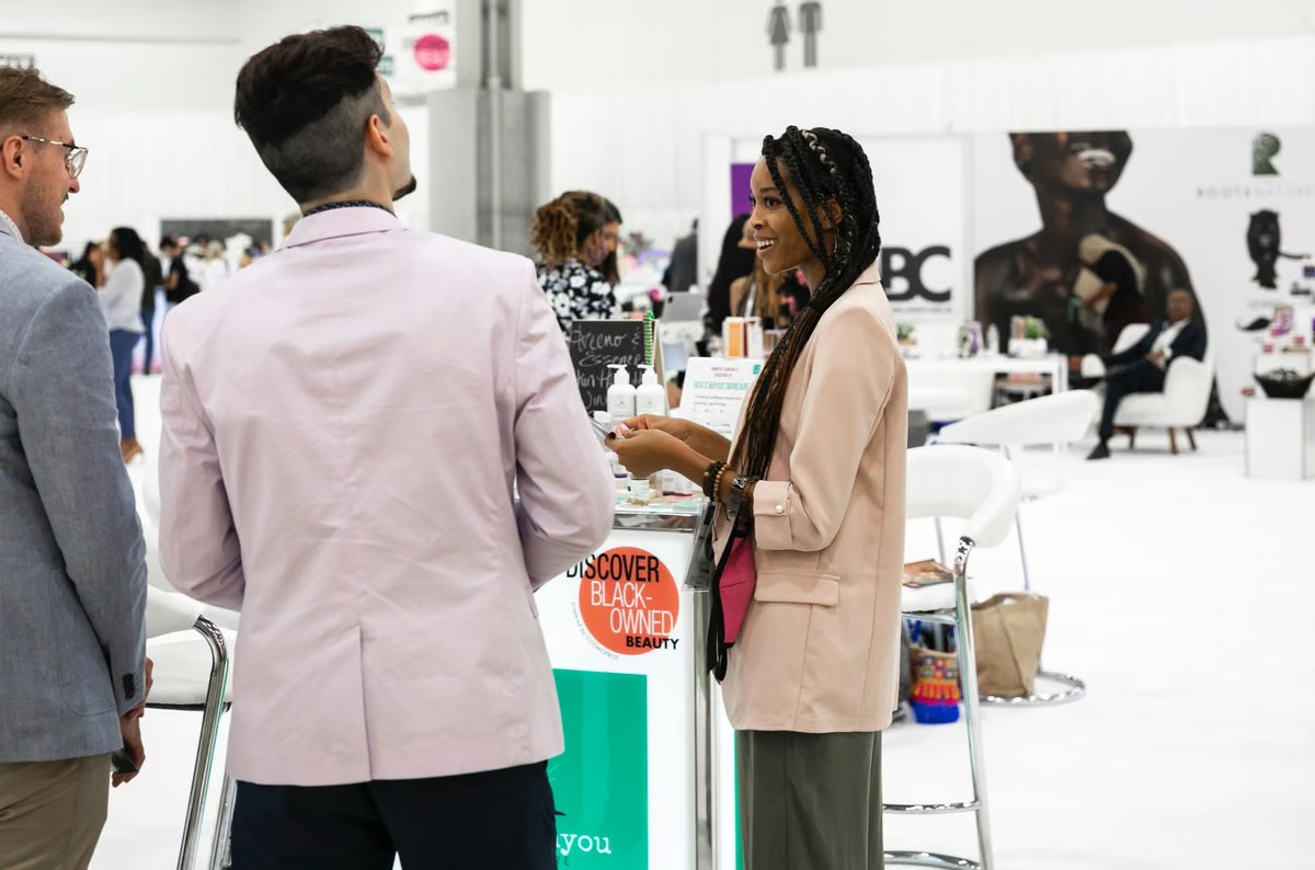 Visitors exploring an automotive exhibition stand during a corporate trade show