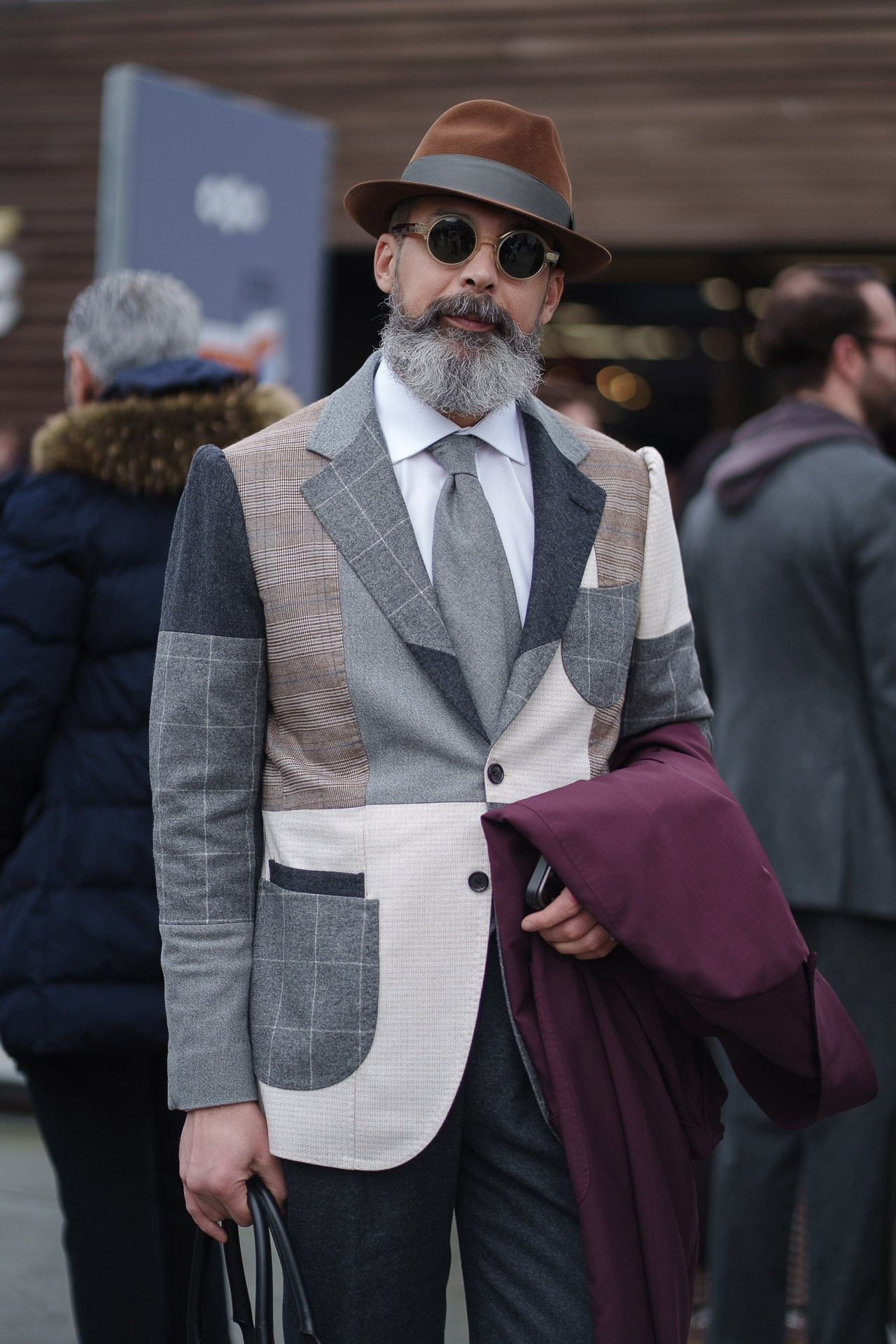 Man in patchwork blazer and fedora hat at Pitti Uomo 109 street style