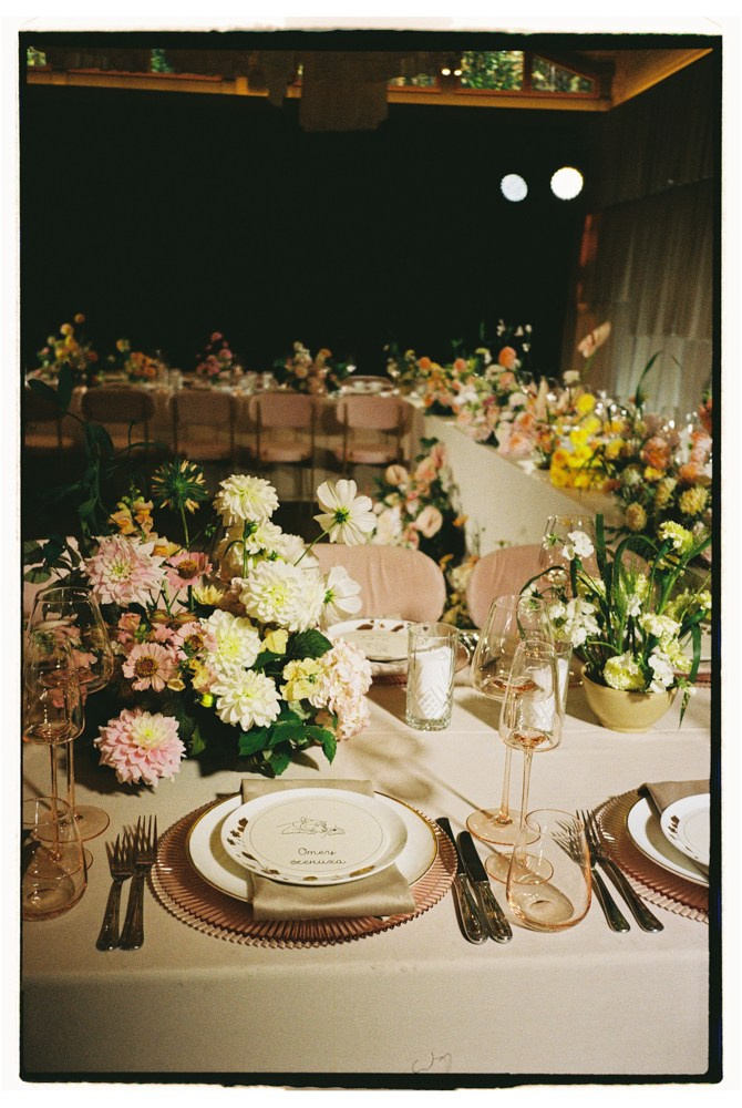 Reception table with pastel florals during editorial wedding dinner
