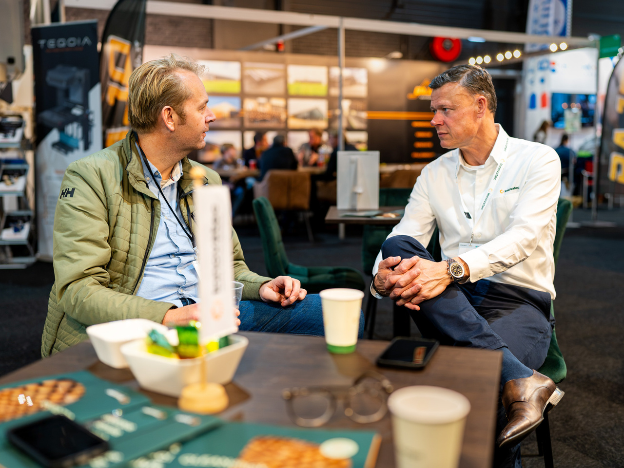 Business discussion between exhibition attendees