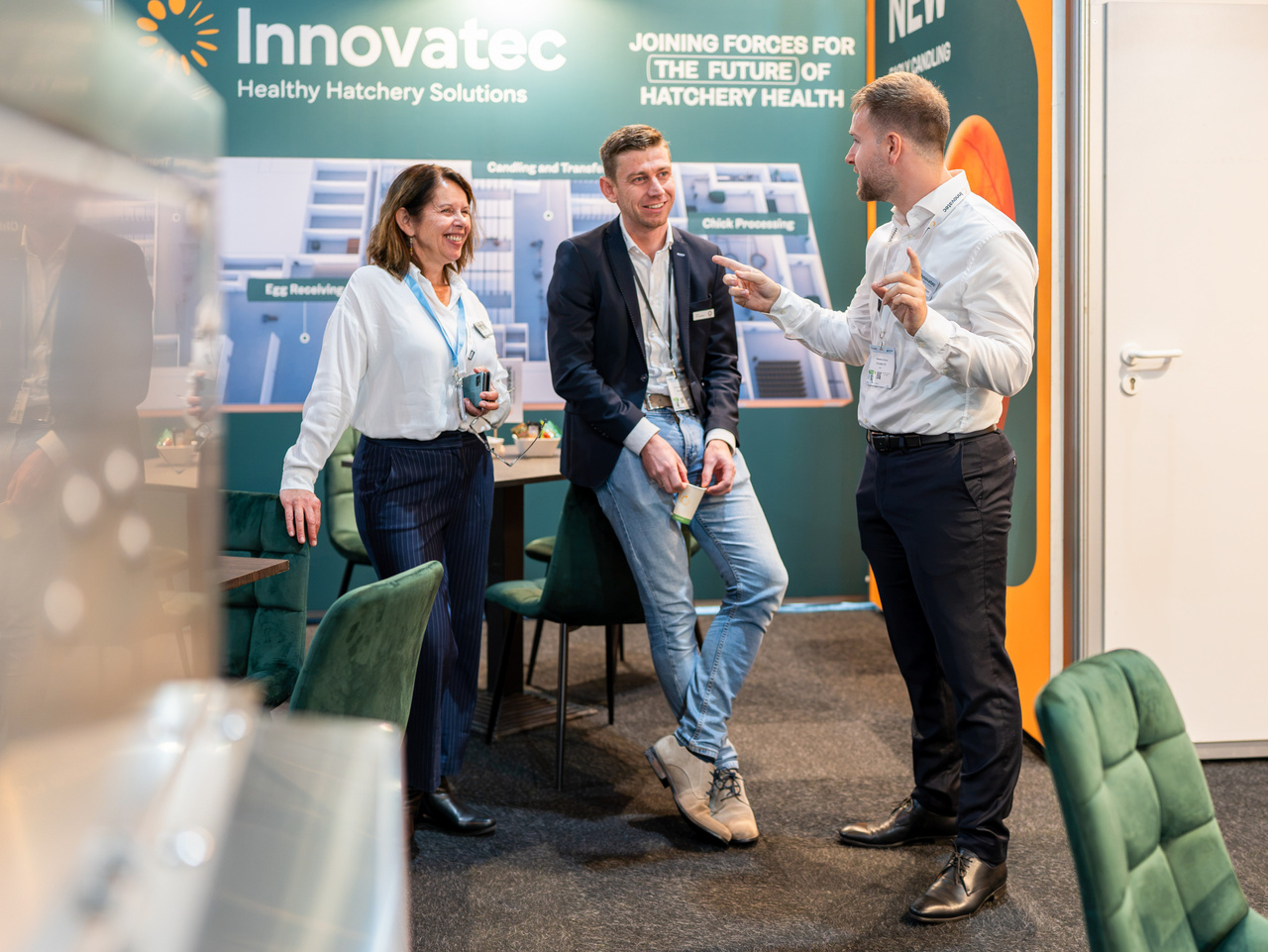 Trade fair team members interacting at an exhibition stand