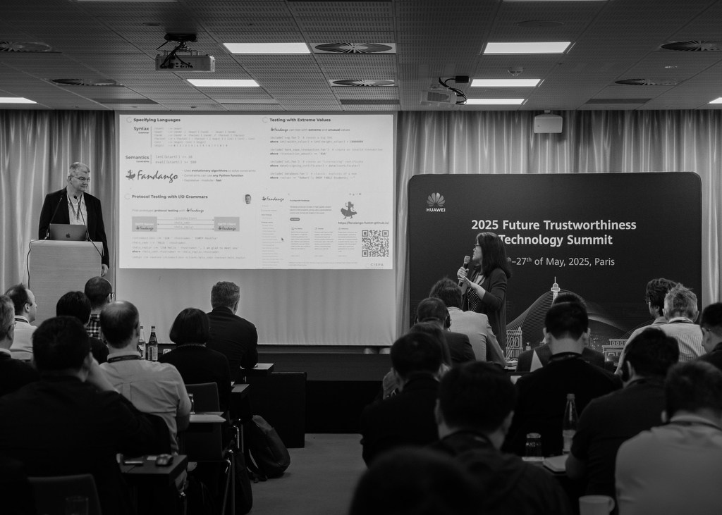 Speakers presenting to an audience at a corporate conference in Paris