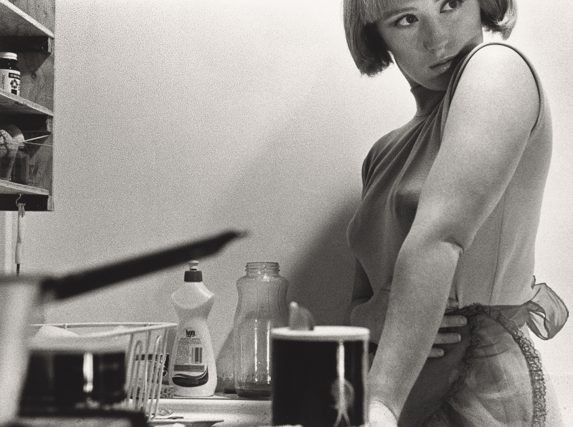 Cindy Sherman's Untitled Film Still #21 (1978) is a seminal work in her groundbreaking series that interrogates female identity and representation through staged self-portraits. In this black-and-white photograph, Sherman embodies a "Hitchcockian 'career girl'" navigating the urban landscape, evoking themes of isolation and introspection .​