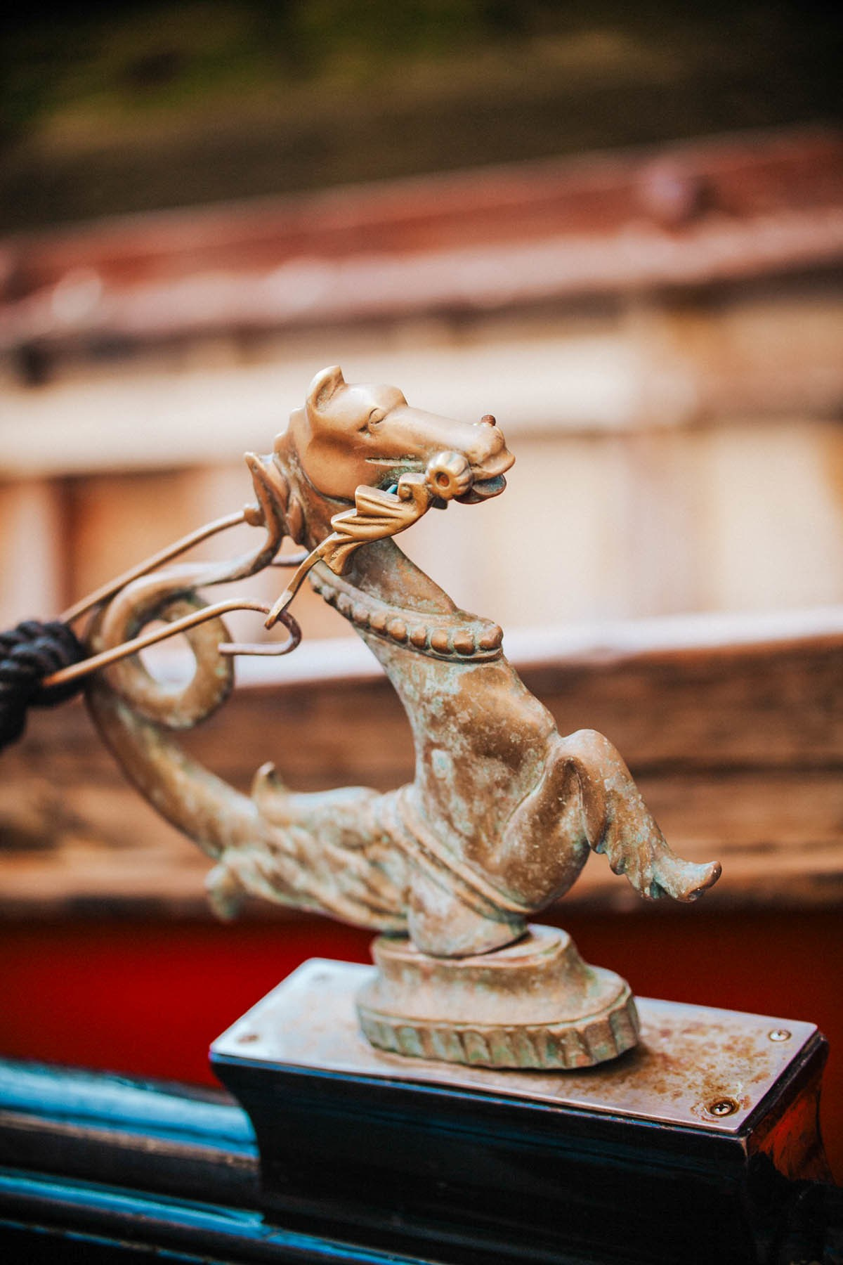 Detailed view of brass seahorse rope holder on traditional Venice gondola.