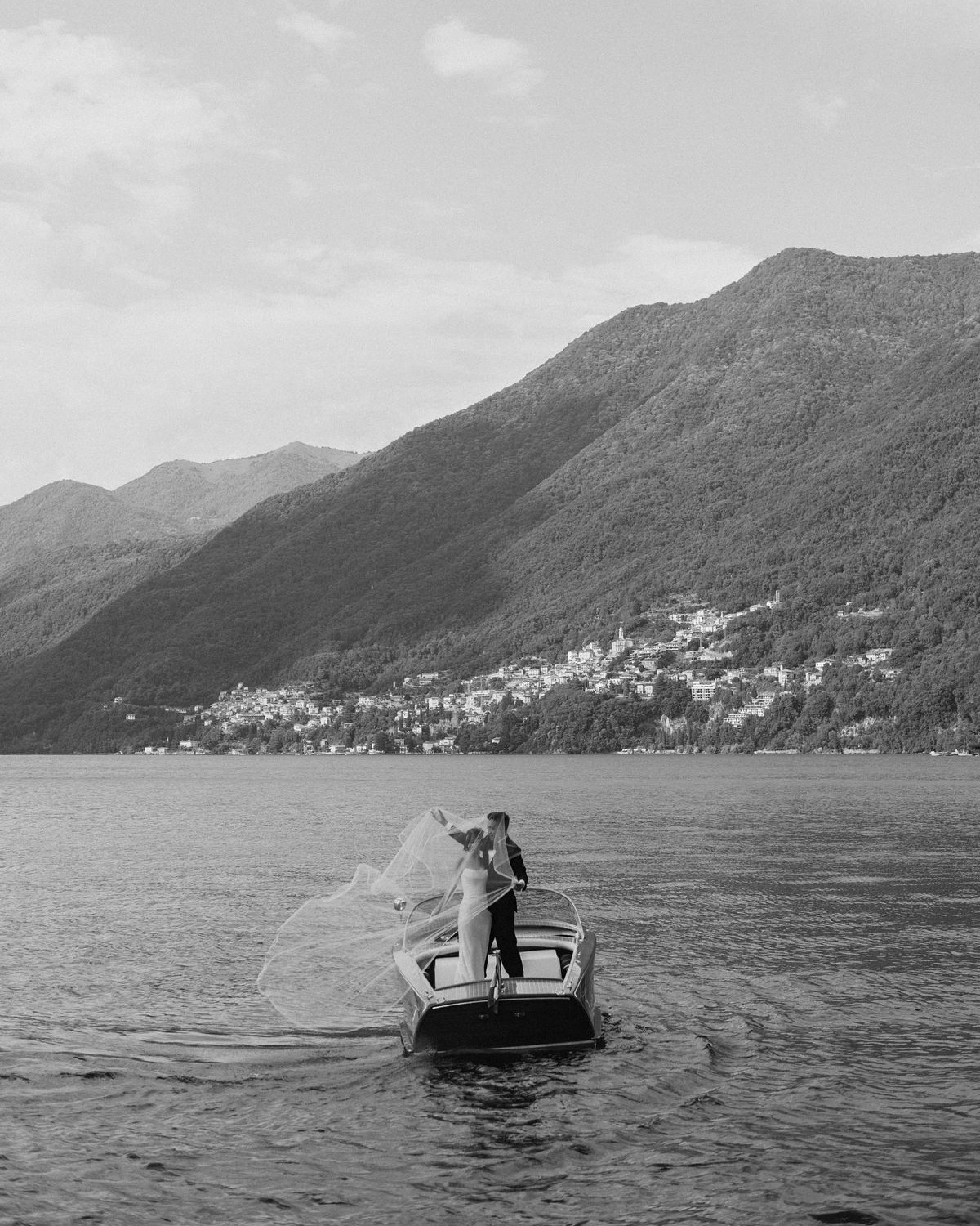 Luxury boat wedding editorial on Lake Como with iconic Italian mountain views