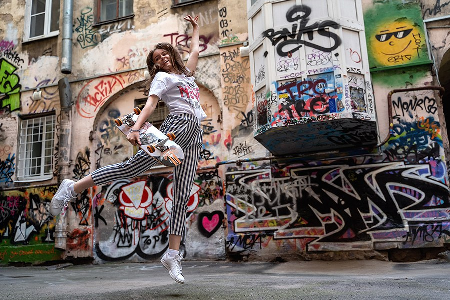 Woman jumping during an outdoor photoshoot. Dynamic and stylish photography