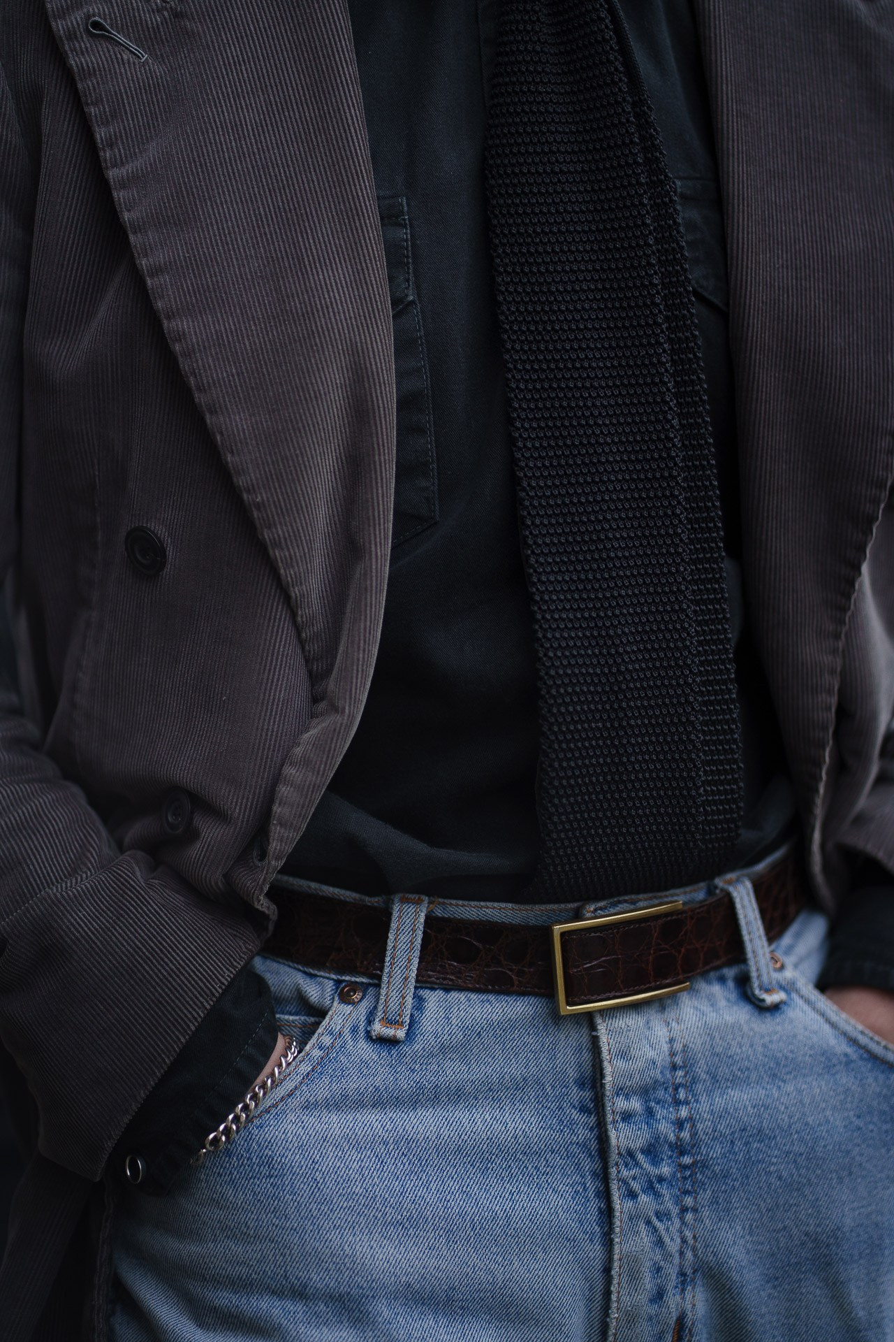 Close up of menswear outfit with brown jacket and jeans during Pitti Uomo