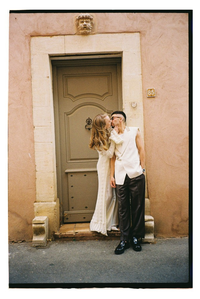 Couple standing by doorway during editorial wedding portraits