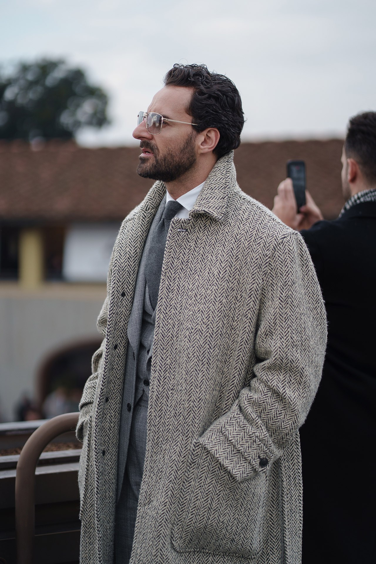 Man in grey wool coat looking to the side at Pitti Uomo 109 Florence