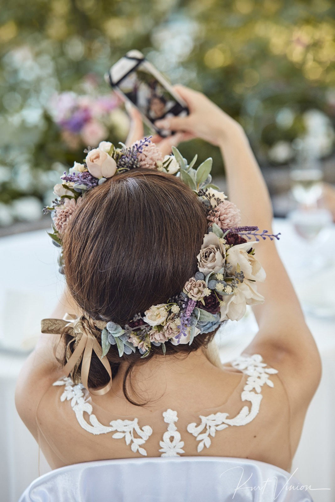 Bride with floral headpiece taking selfie Bled Island church.