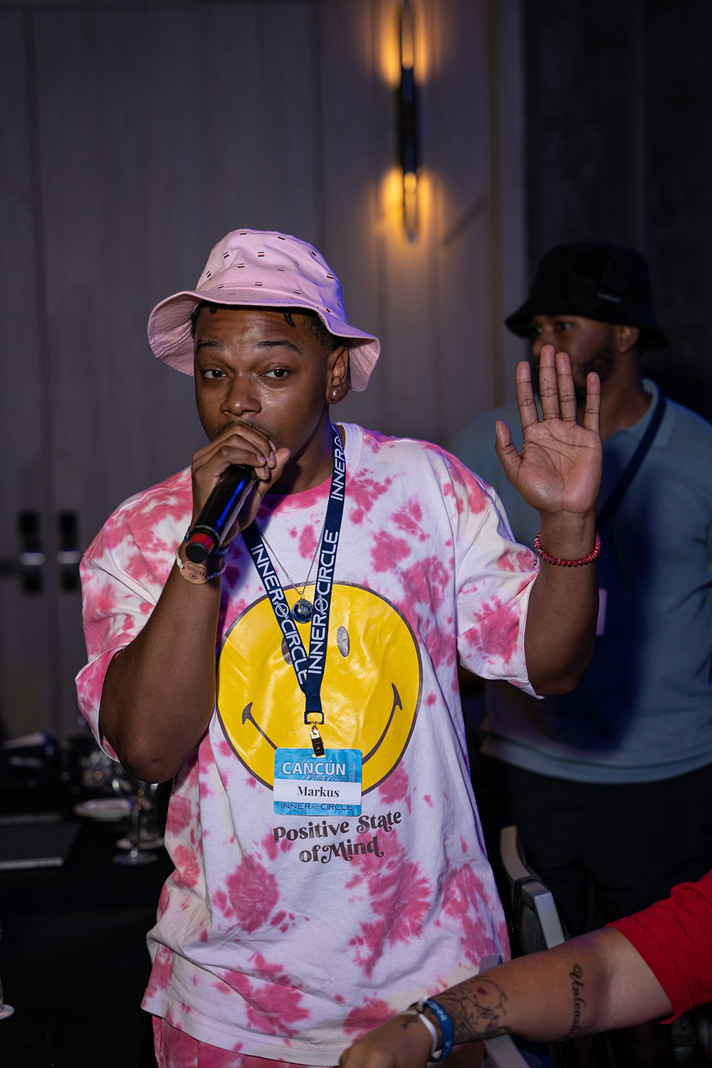 Corporate guest asking insightful question through handheld mic.