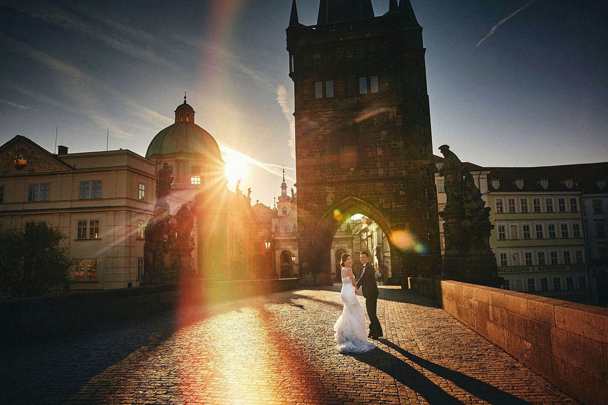 Singapore couple Charles Bridge gothic tower sunrise flare