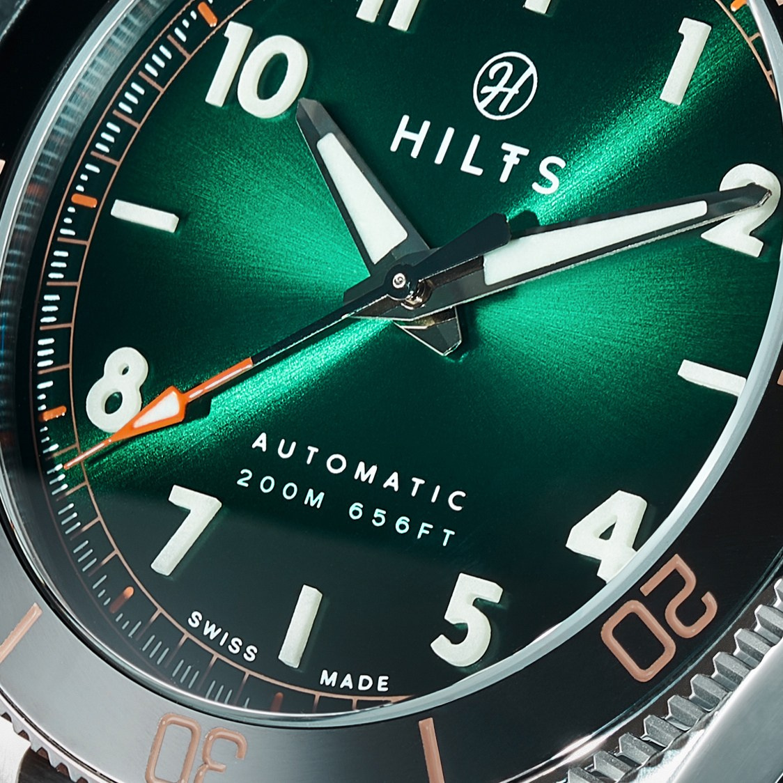 Green sunburst dial of a watch automatic diver, macro detail of hands and markers