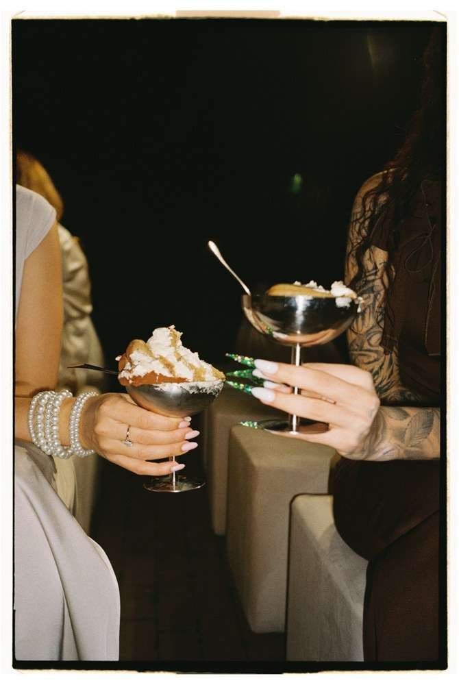 Guests holding desserts during destination wedding reception in Tuscany, Italy