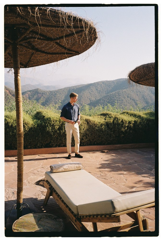 Man standing near lounger during Morocco destination wedding morning
