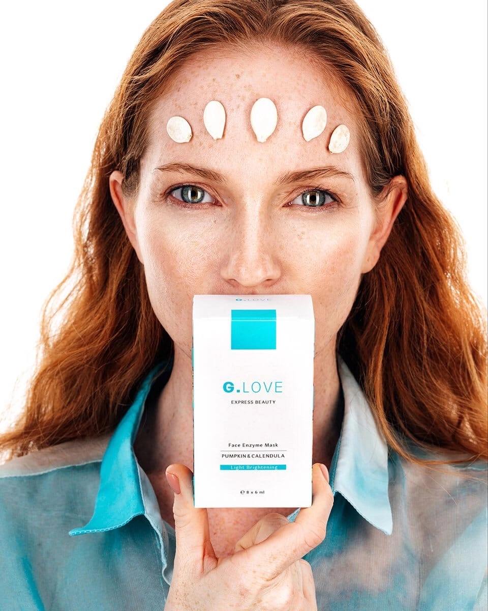 Portrait of a model with a serene expression on a white background, showcasing her natural beauty with minimal makeup. Her hair is styled neatly, emphasizing her facial features. The image highlights the elegance and simplicity of her look, capturing a moment of quiet confidence and grace.
