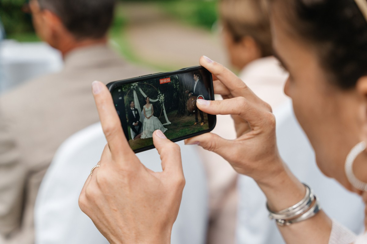 Guest making a photo during ceremony