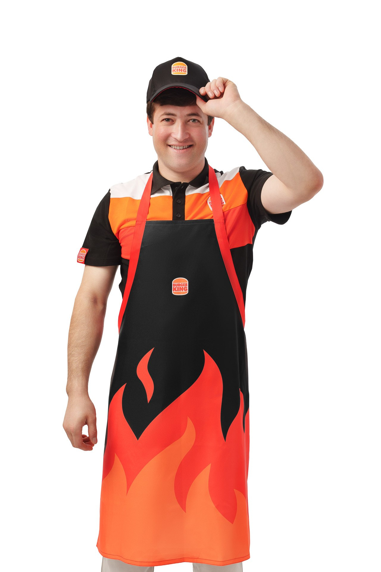 Burger King employee in branded uniform and cap, studio portrait on white background