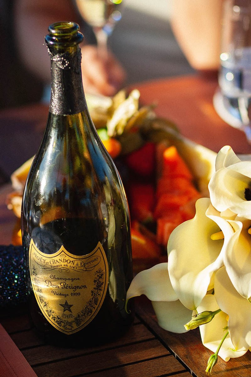 A vintage bottle of Dom Perignon and the bride's bouquet.