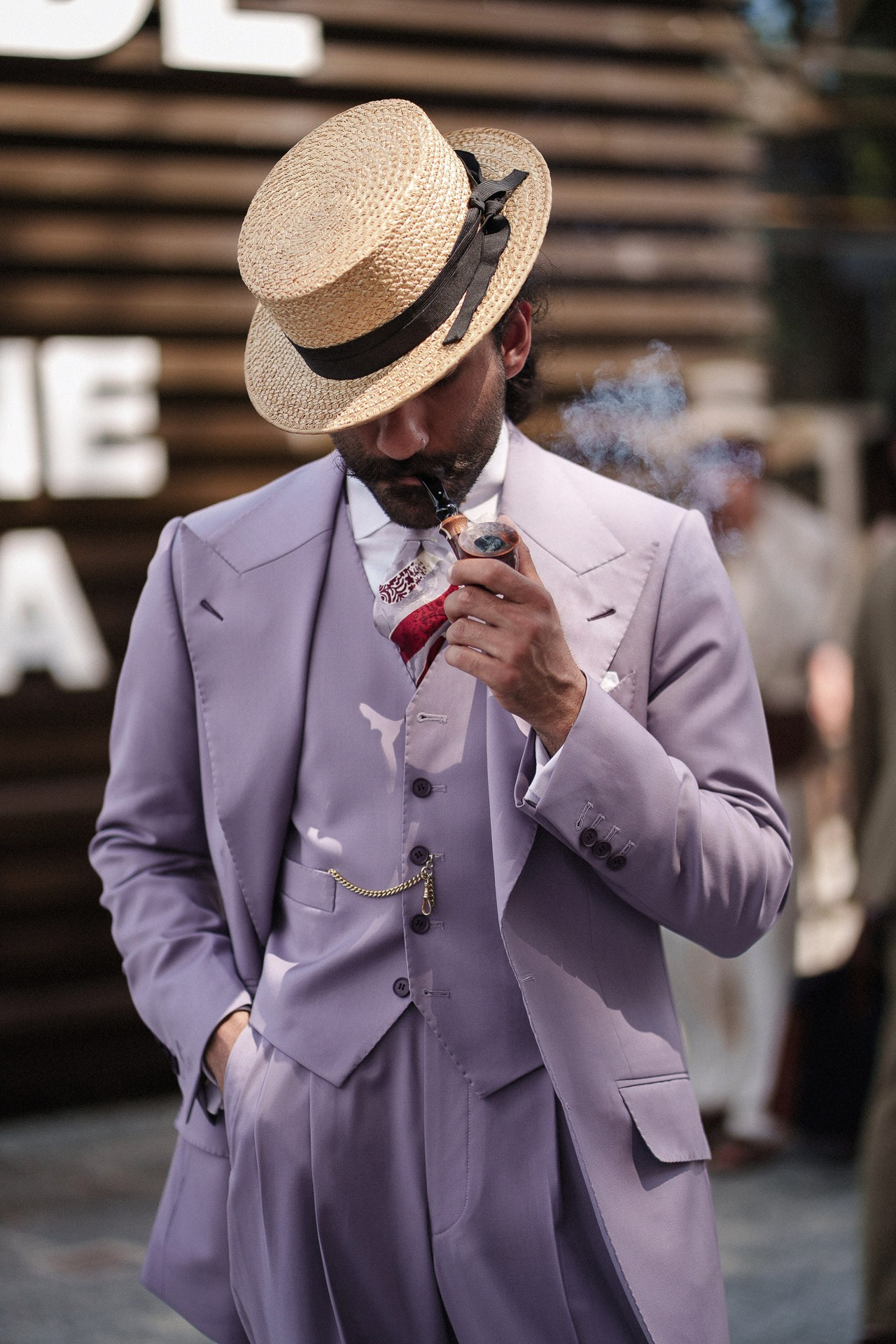 Pitti Uomo 110 menswear portrait, guest in lilac three-piece suit and straw hat outside Fortezza da Basso