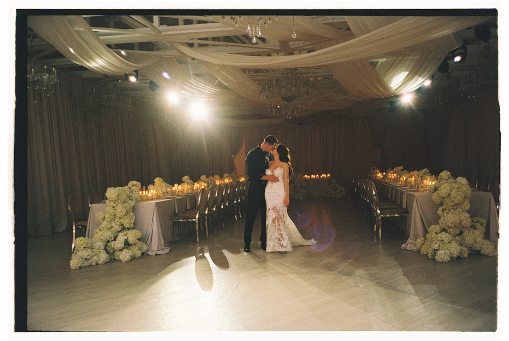 Bride and groom first dance during indoor destination wedding reception