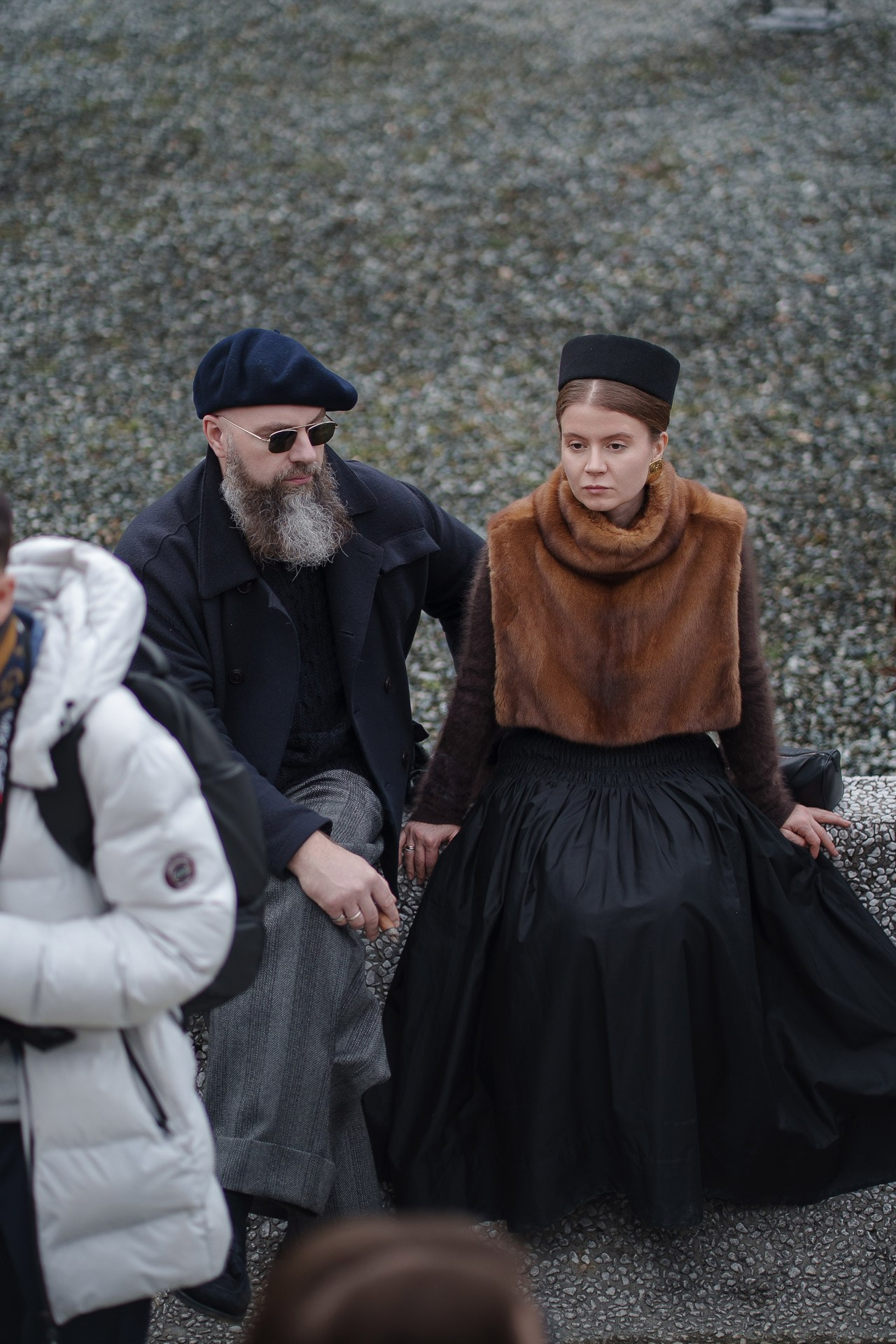 Stylish couple sitting together at Pitti Uomo 109 Florence street style