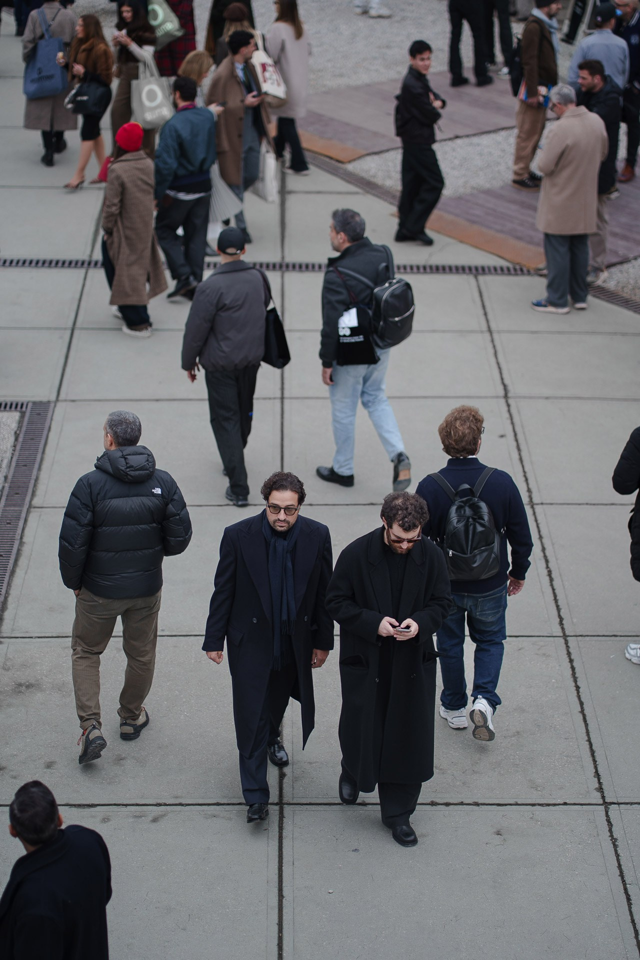 Overhead view of people walking outside Pitti Uomo 109 Florence