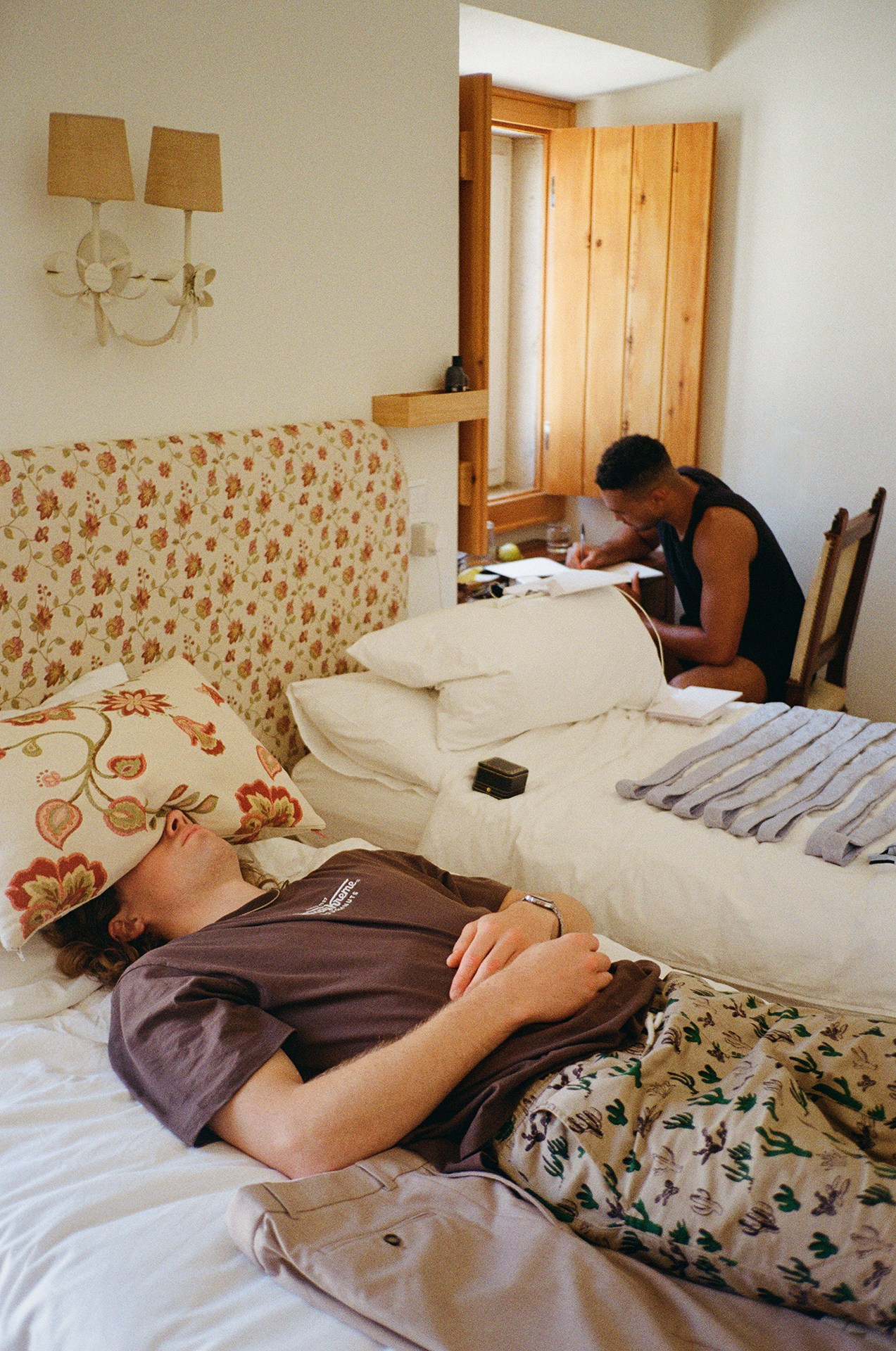 Groom relaxing on a bed before the wedding ceremony, candid getting ready moment at Portugal wedding