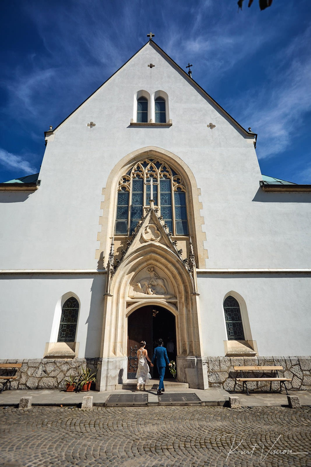 Japanese couple entering St Martin's Church Bled town hall wedding.