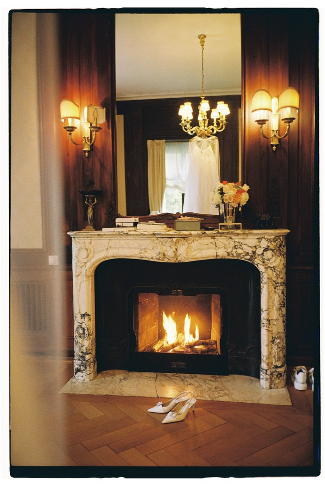 Editorial wedding details by fireplace with shoes on parquet