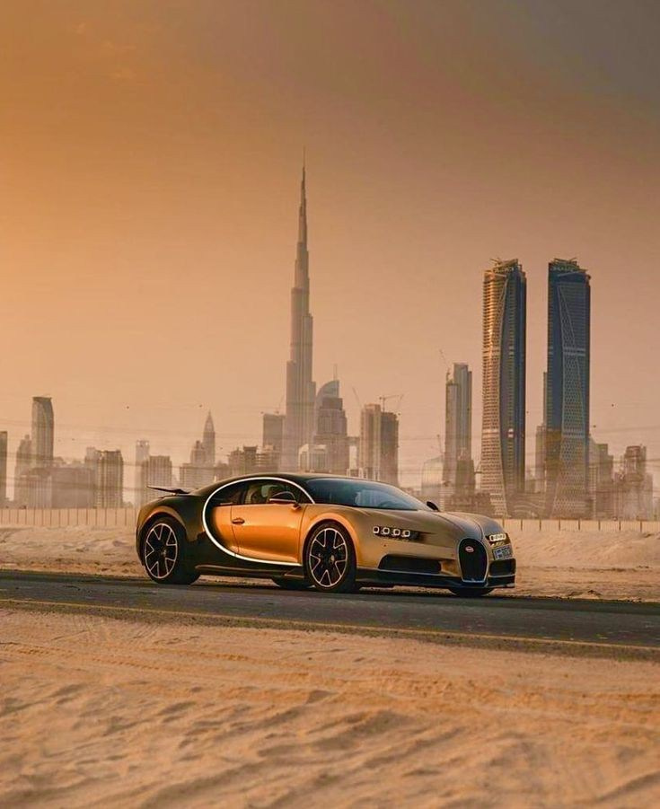 Golden Bugatti with Burj Khalifa at sunset:“Golden Bugatti on asphalt in Dubai with Burj Khalifa and skyscrapers in the sunset background.”