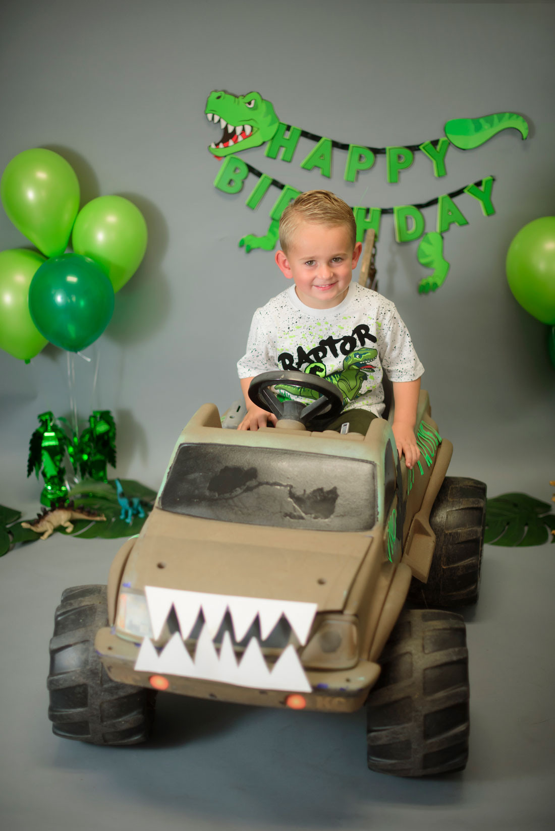 Dinosaur monster truck decorated birthday photography in Lincoln, CA. Family photographer in Roseville, Rocklin, Folsom, Sacramento