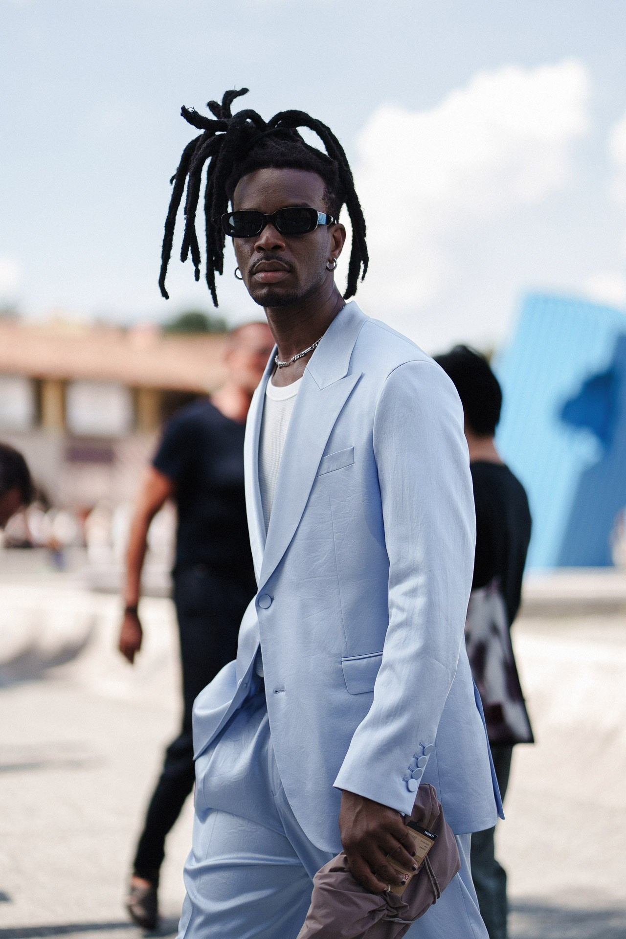 Street style portrait from Pitti Uomo 110, guest in pale blue summer suit and sunglasses