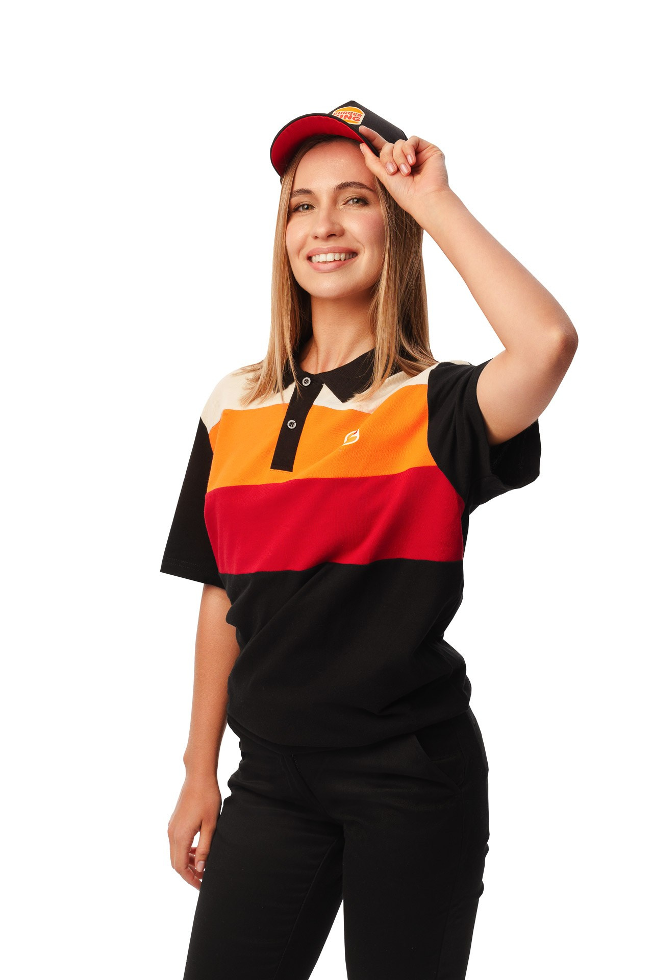 Female Burger King employee smiling in branded uniform, studio portrait