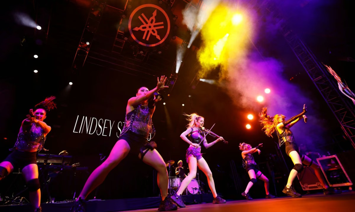 Live band performing under colourful stage lighting at an event