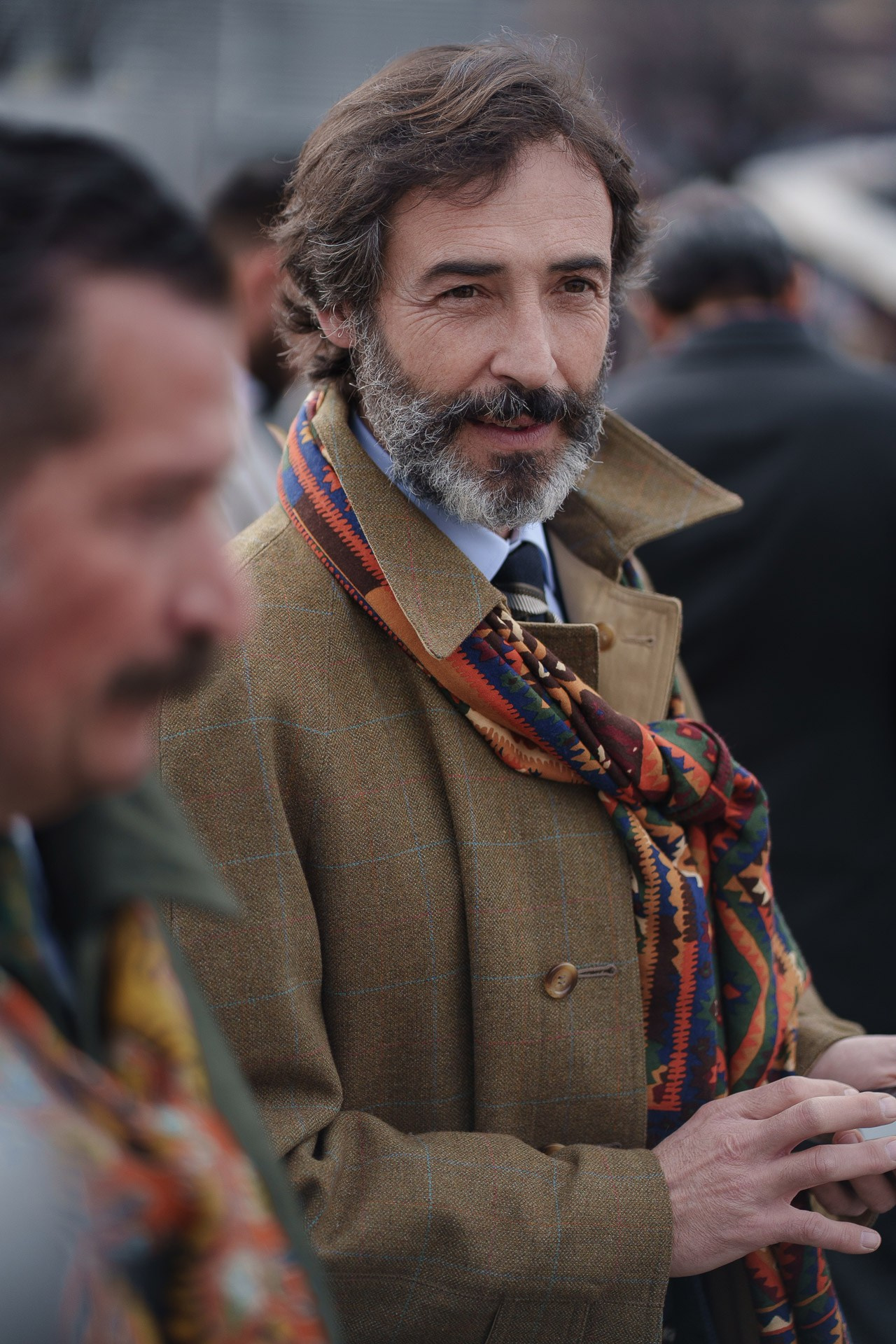 Man in brown coat and patterned scarf at Pitti Uomo Florence