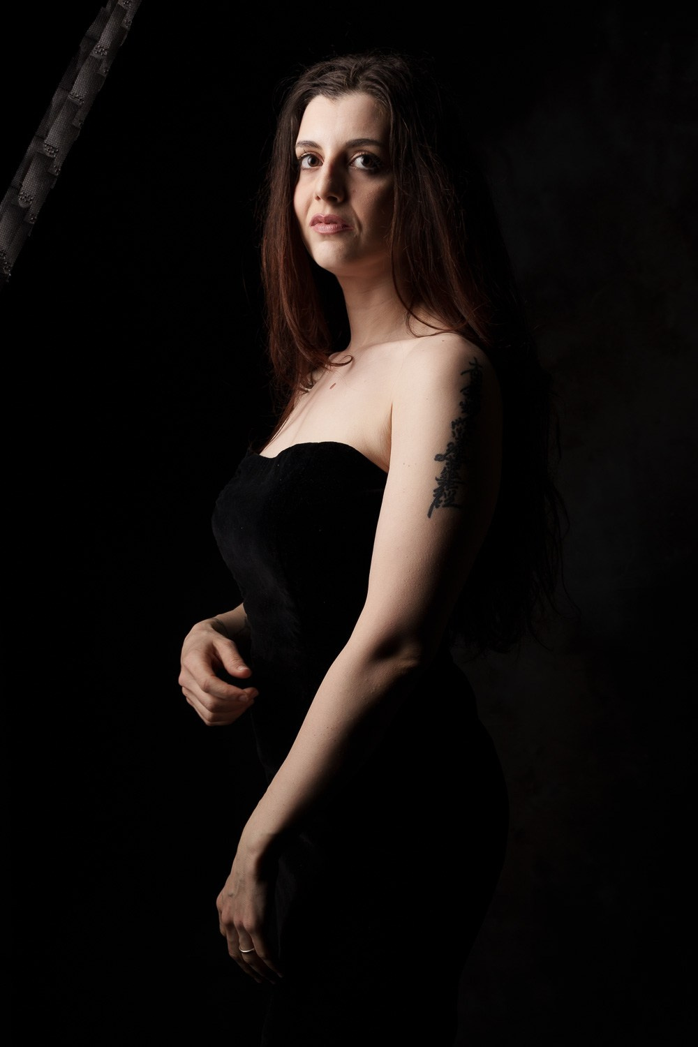 Model photoshoot playing with strip soft box with grid. 