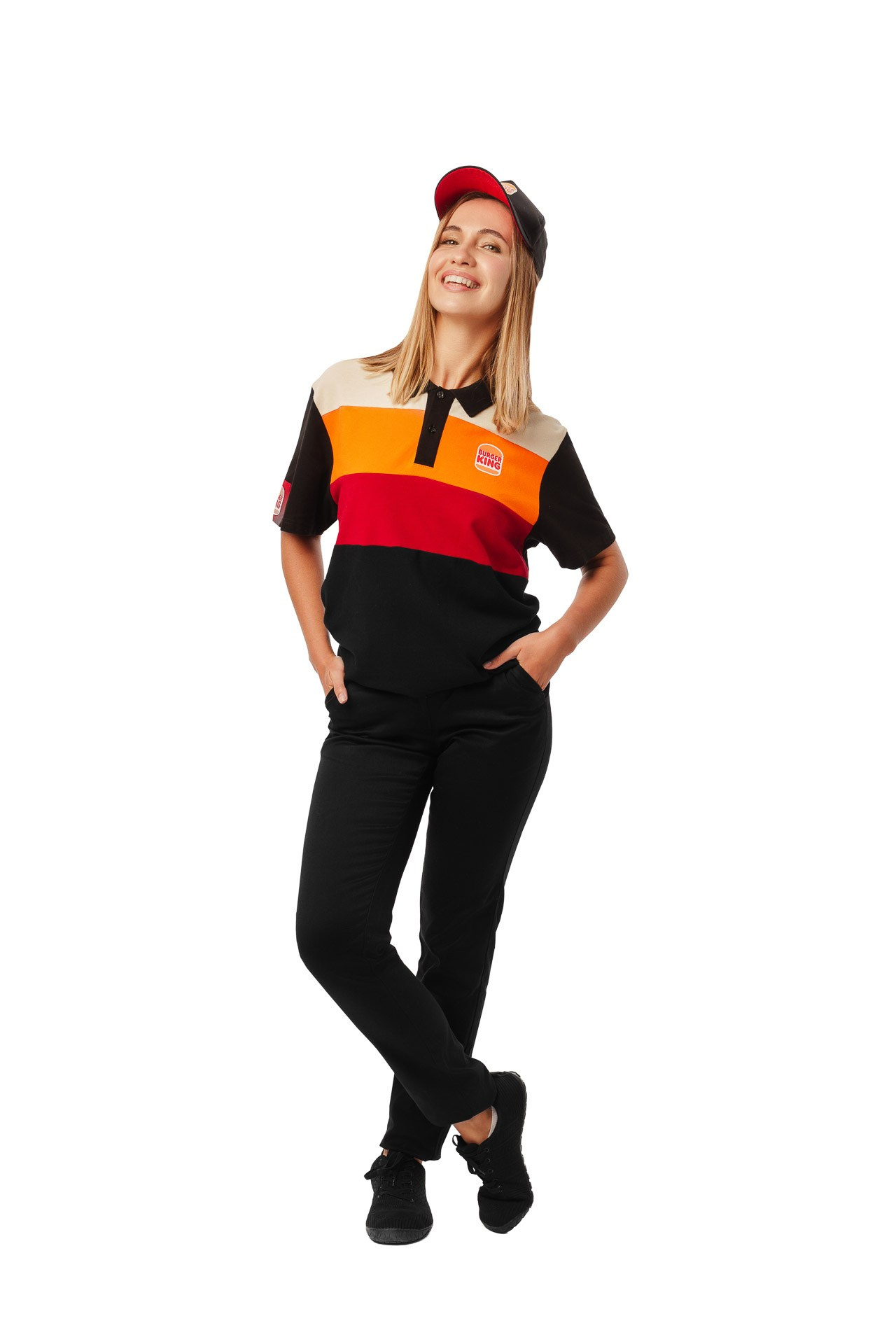 Female Burger King employee in uniform, full body studio portrait on white background