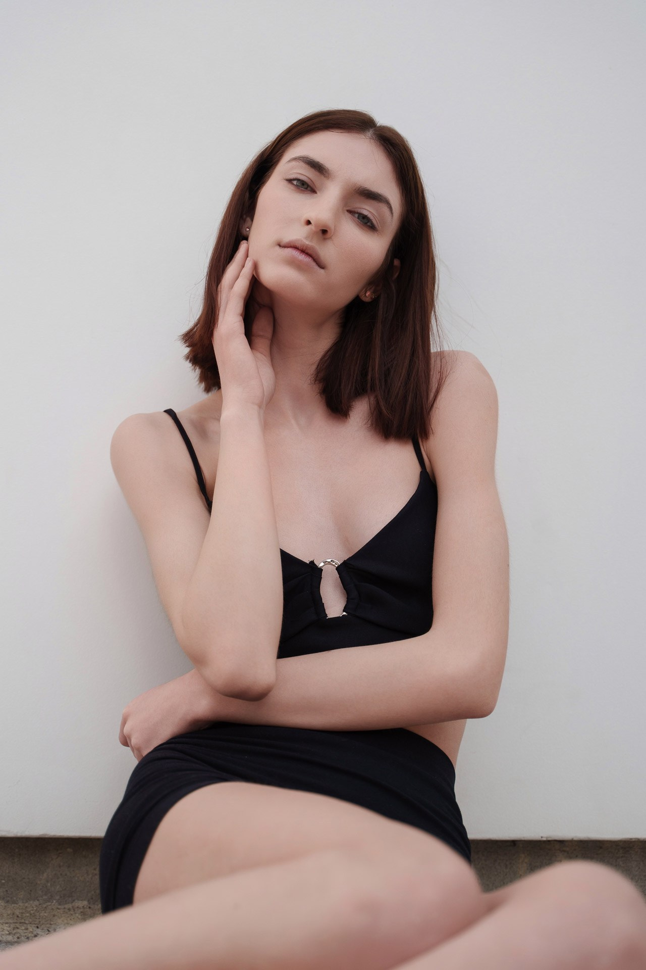 Close-up model test portrait of a young woman with natural makeup against a white background