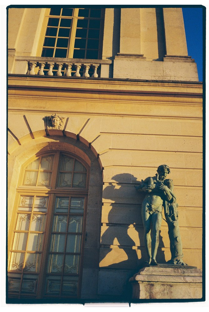 Historic building facade with statue during destination wedding venue setup